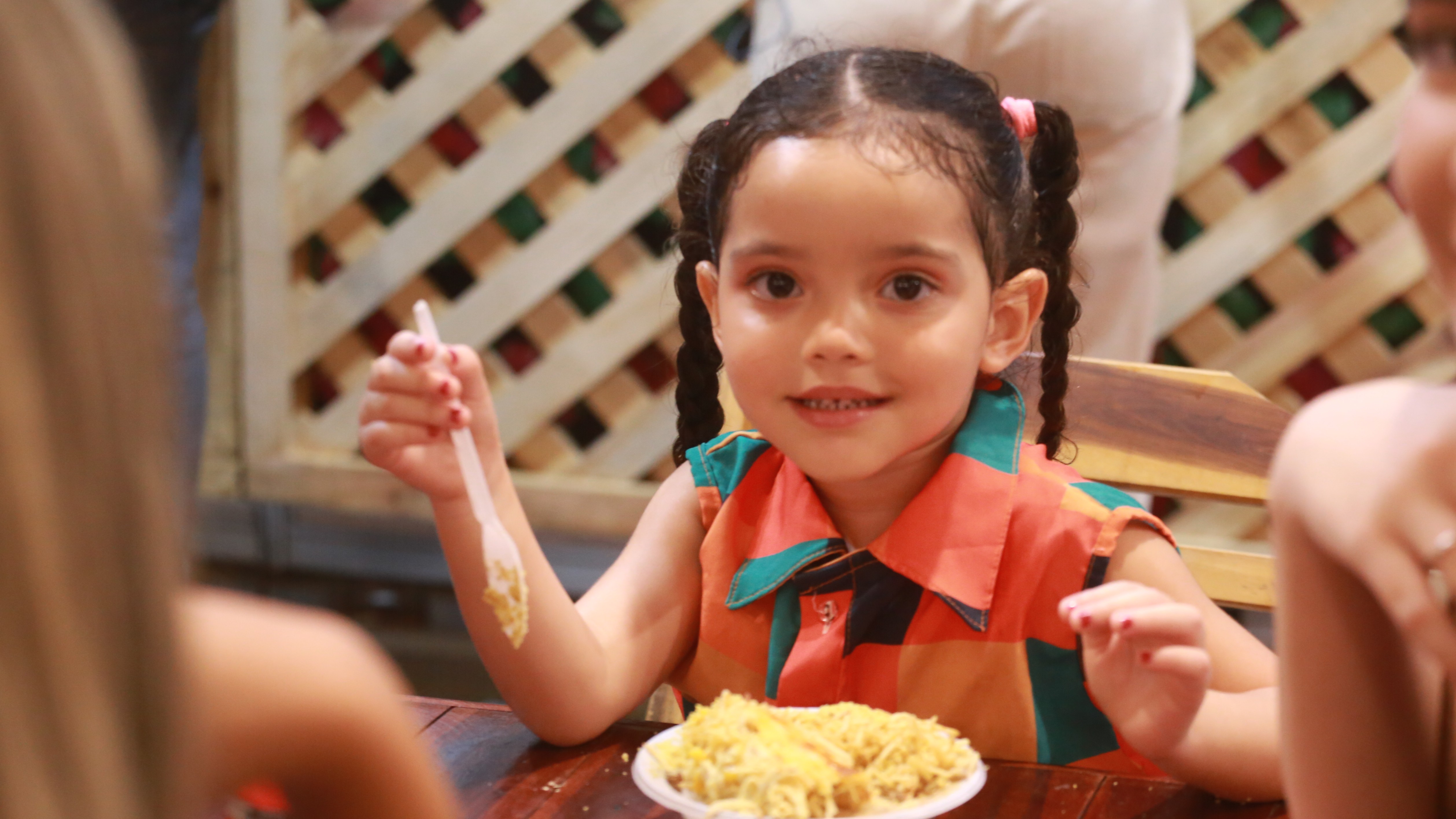 menina com um pratinho de creme de galinha 